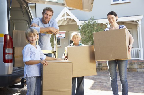 Professional movers handling furniture in a Brentford flat