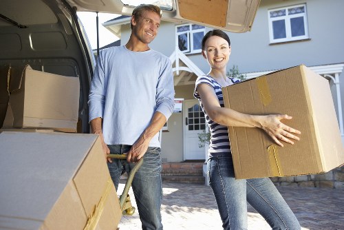 Professional removals team handling boxes and household items